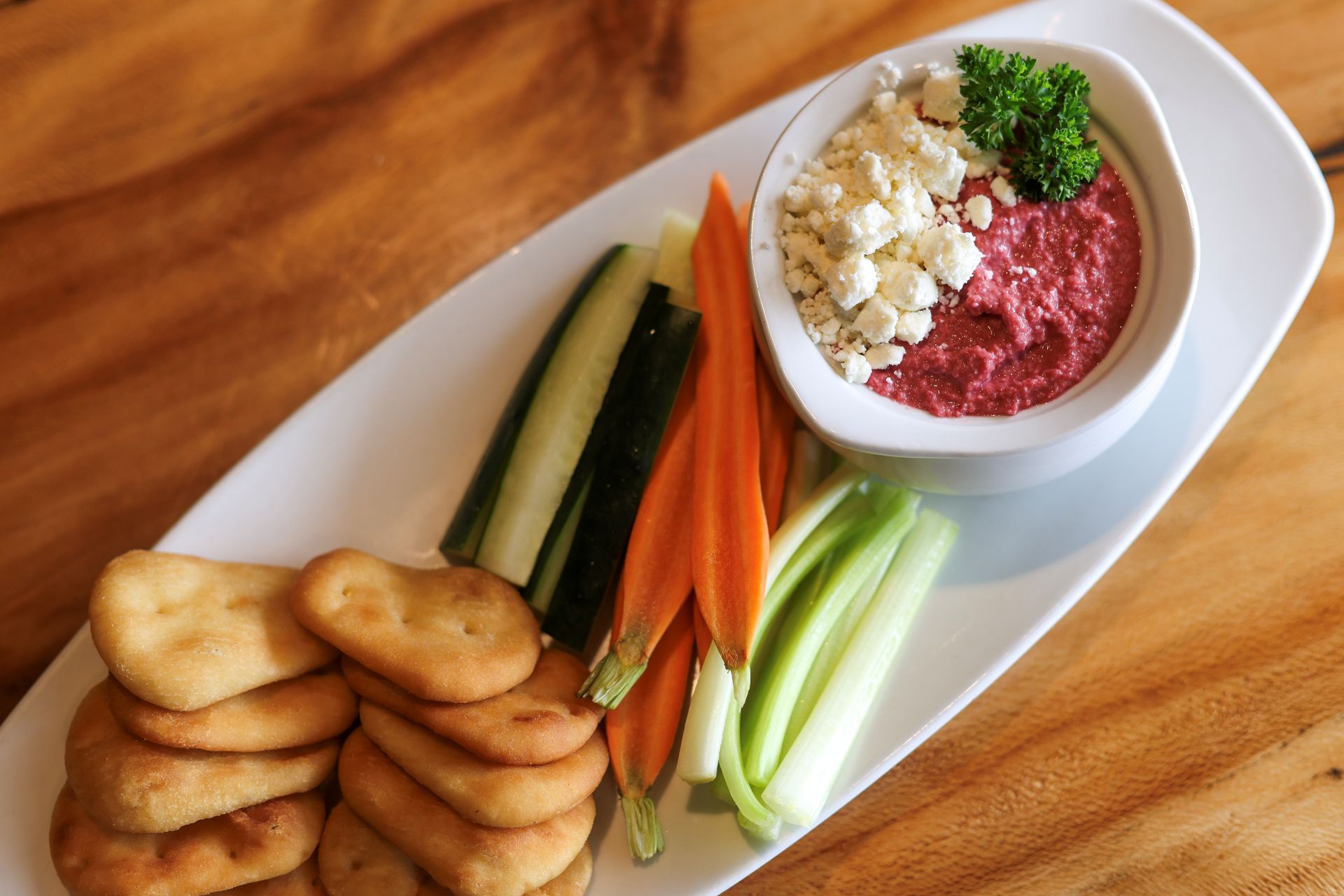 Beet Hummus - Roasted Beets, Tahini, Chickpeas, Feta Cheese, Fried Pita, Cucumber, Celery, Carrots, & Peppers