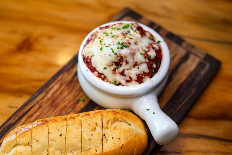 Fort Mccoy Meatballs - DBK Beef & Brisket Blend Meatballs, Choice of Garlic Parmesan or Marinara Sauce Served with Toasted Cuban Bread