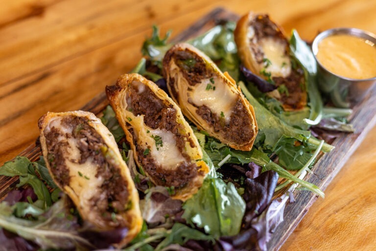 Philly Cheesesteak Eggrolls - Shaved Prime Rib, Green Pepper, Onion, Aged Provolone, Served with House Queso