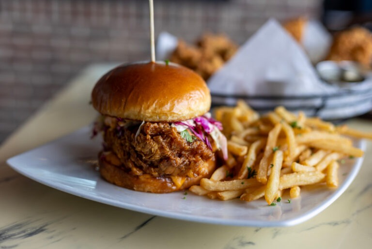 Hot Honey Fried Chicken Burger - Food Delivery - Golden Fried Chicken Breast Tossed in Hot Honey Sauce, Fresh & Tangy Slaw, Chipotle Aioli, Sweet Hottie Pickles, Brioche Bun