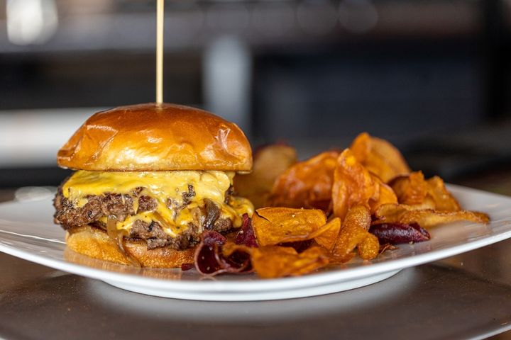 The District Burger - (2) Quarter Pound DBK Brisket & Beef Blend Smash Patties, American Cheese, Caramelized Onions, Roasted Garlic Aioli, Sweet Hottie Pickles, Brioche Bun